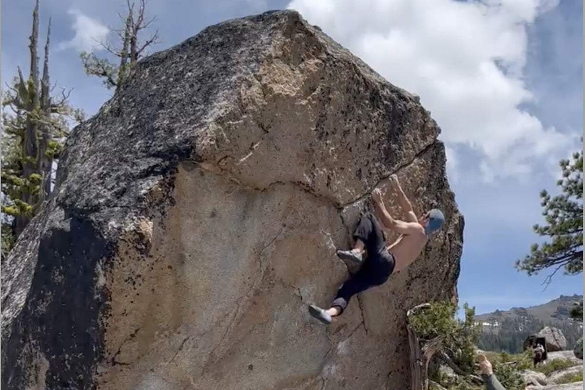 Sesh crew climber on Gold as the Sky (V5), a gold granite erratic at Erratica near Kirkwood