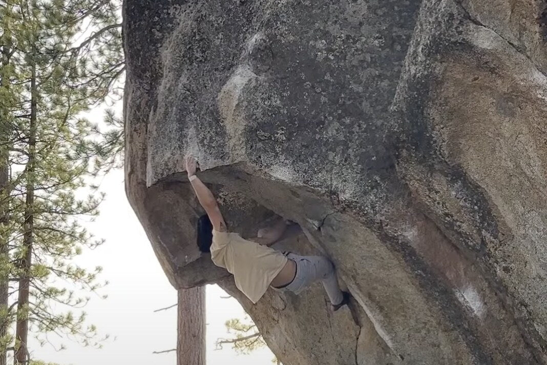 A climber pulling through the roof on Peace of Mind, The Zephyrs, Lake Tahoe