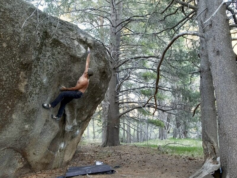 A climber on a granite boulder at Pie Shop in South Lake Tahoe
