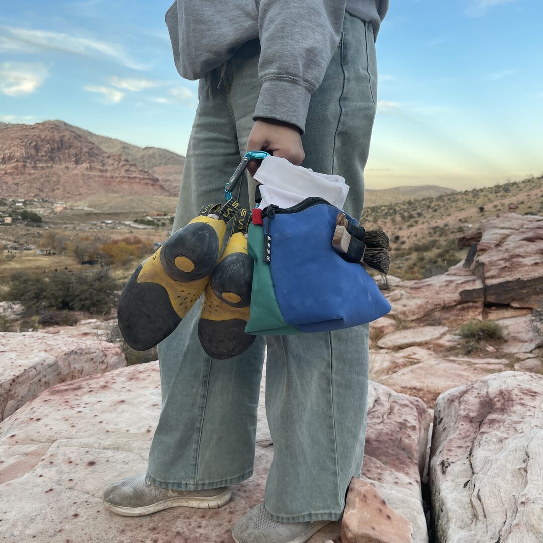 Climber with a Sesh bucket at the crag